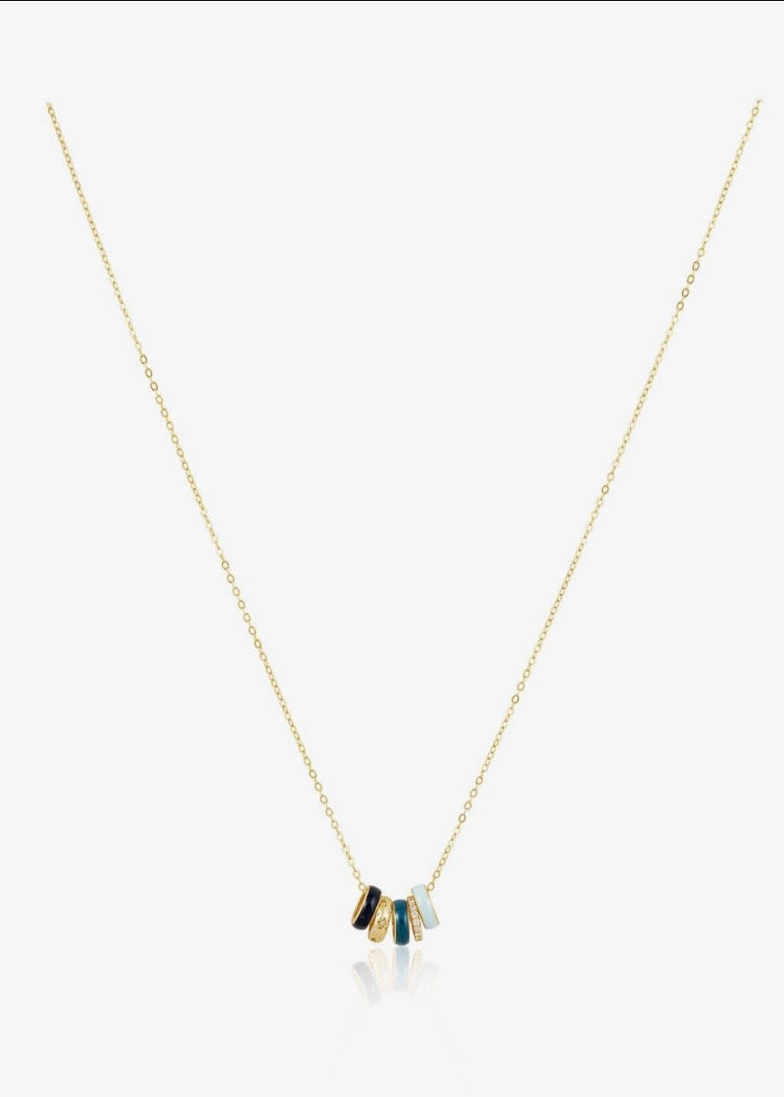 Gold necklace with colorful pendant on a white background