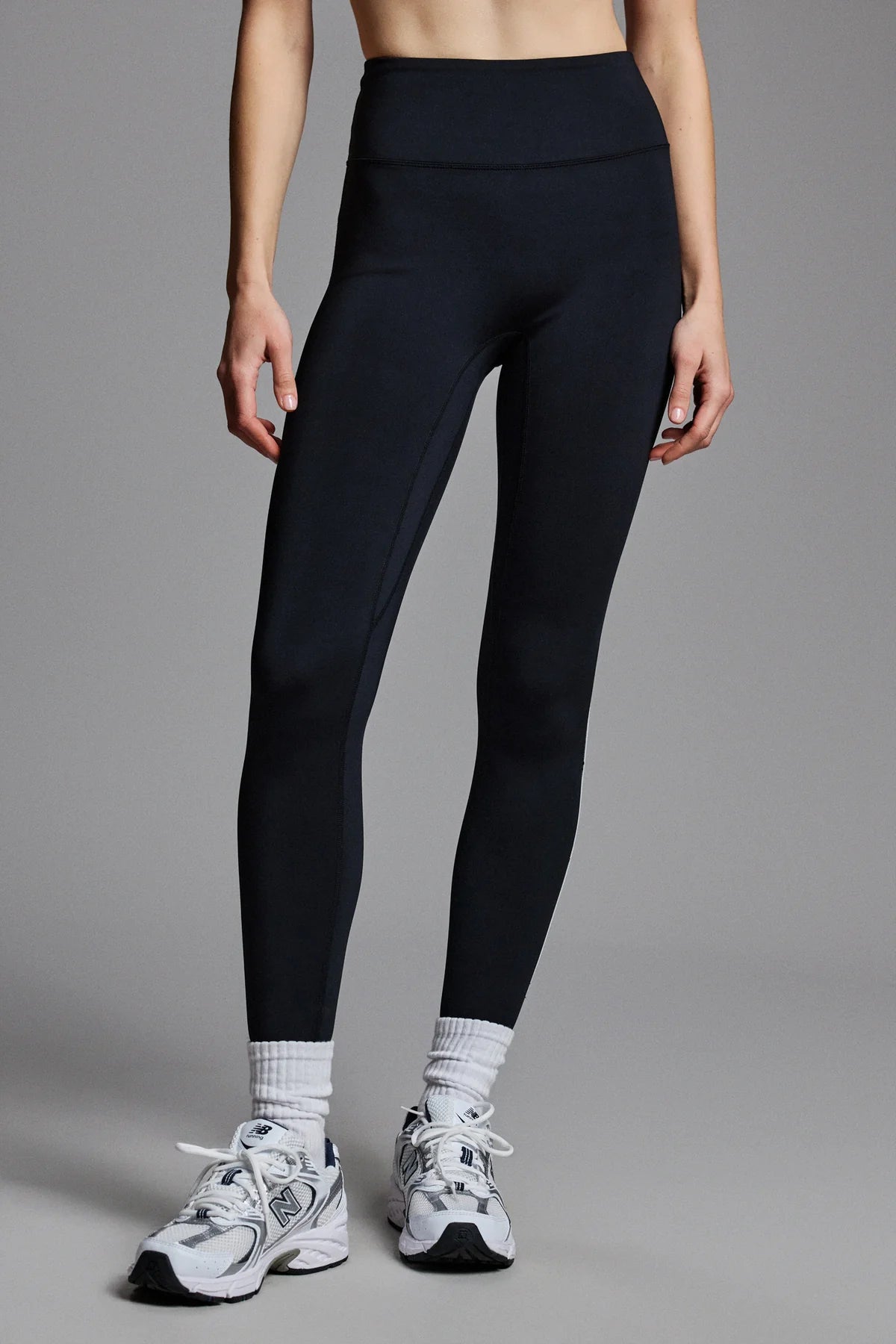Person wearing black leggings and white sneakers 