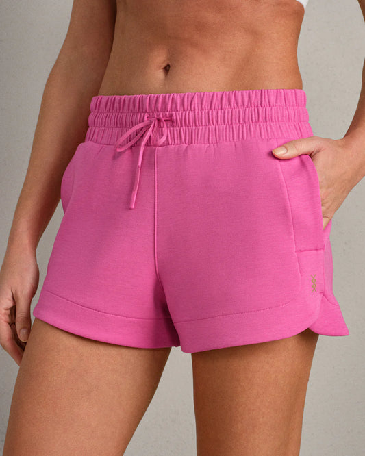 Person wearing bright pink shorts 