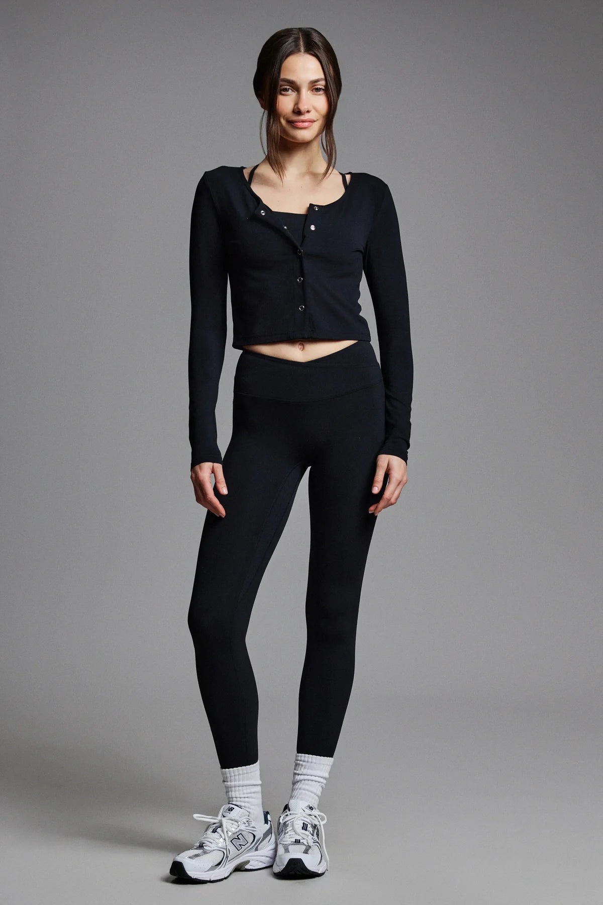 Woman wearing a black long-sleeve top and leggings