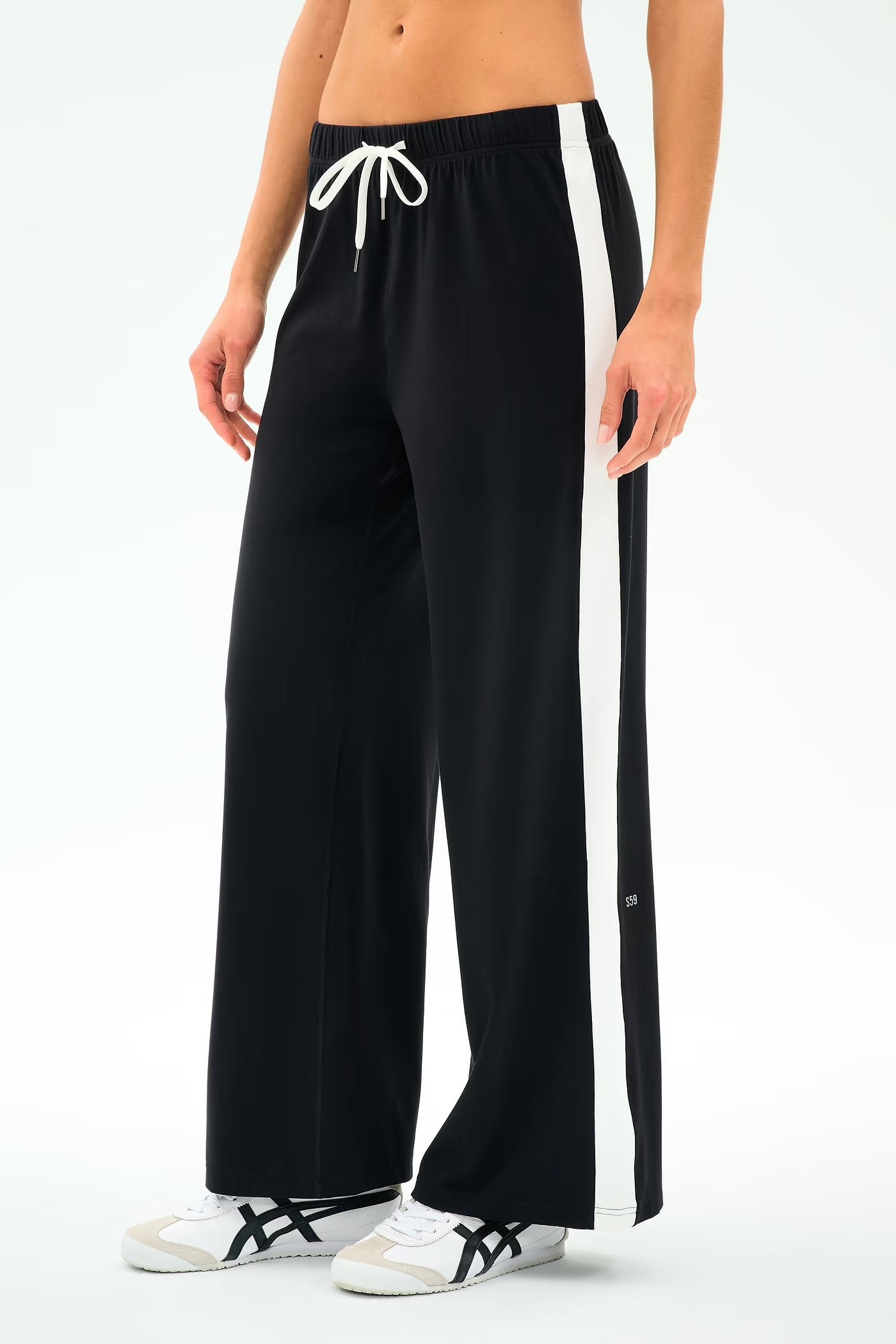 Black wide-leg pants with a white drawstring and side stripe worn by a person 
