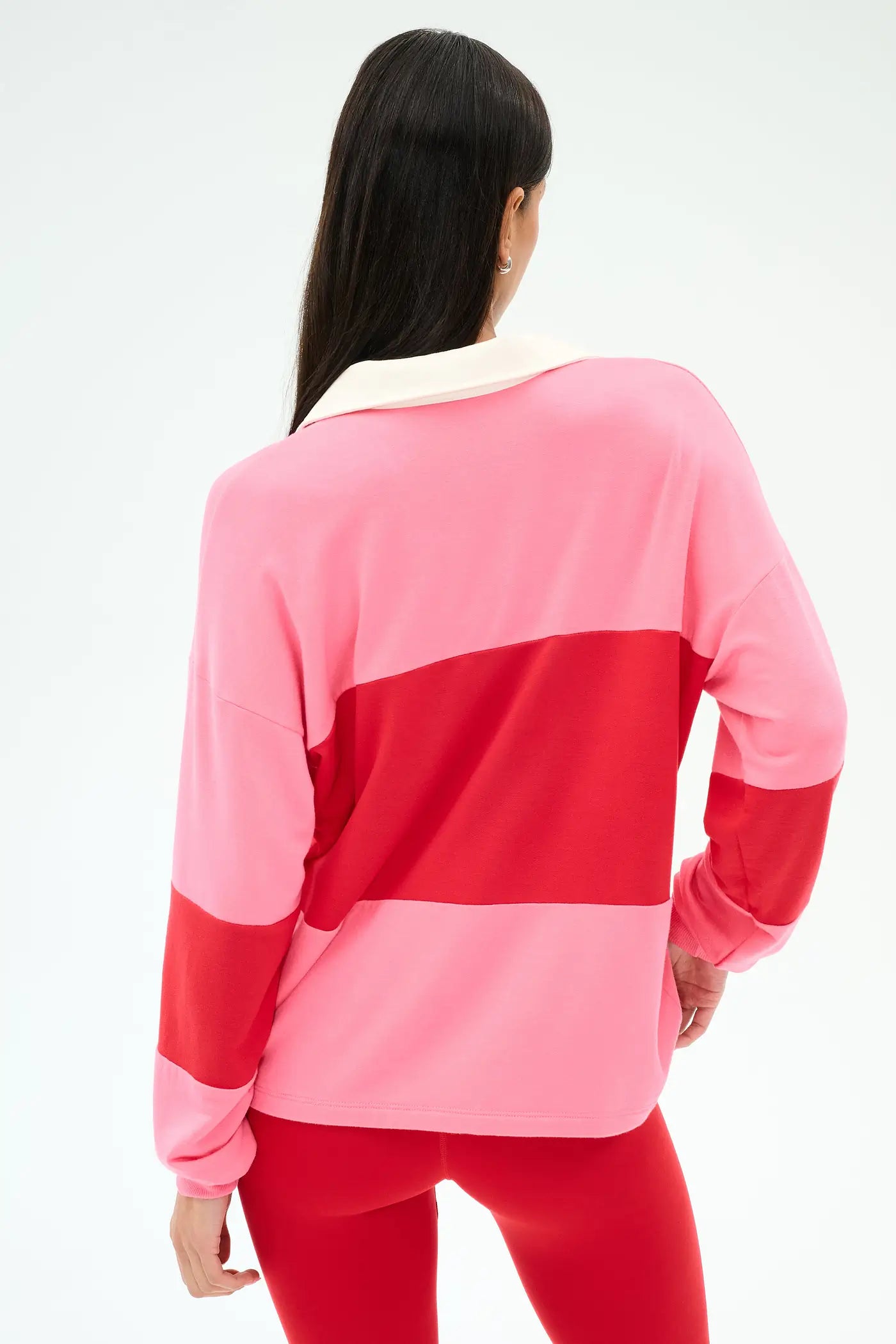 Person wearing a pink and red color-blocked outfit.