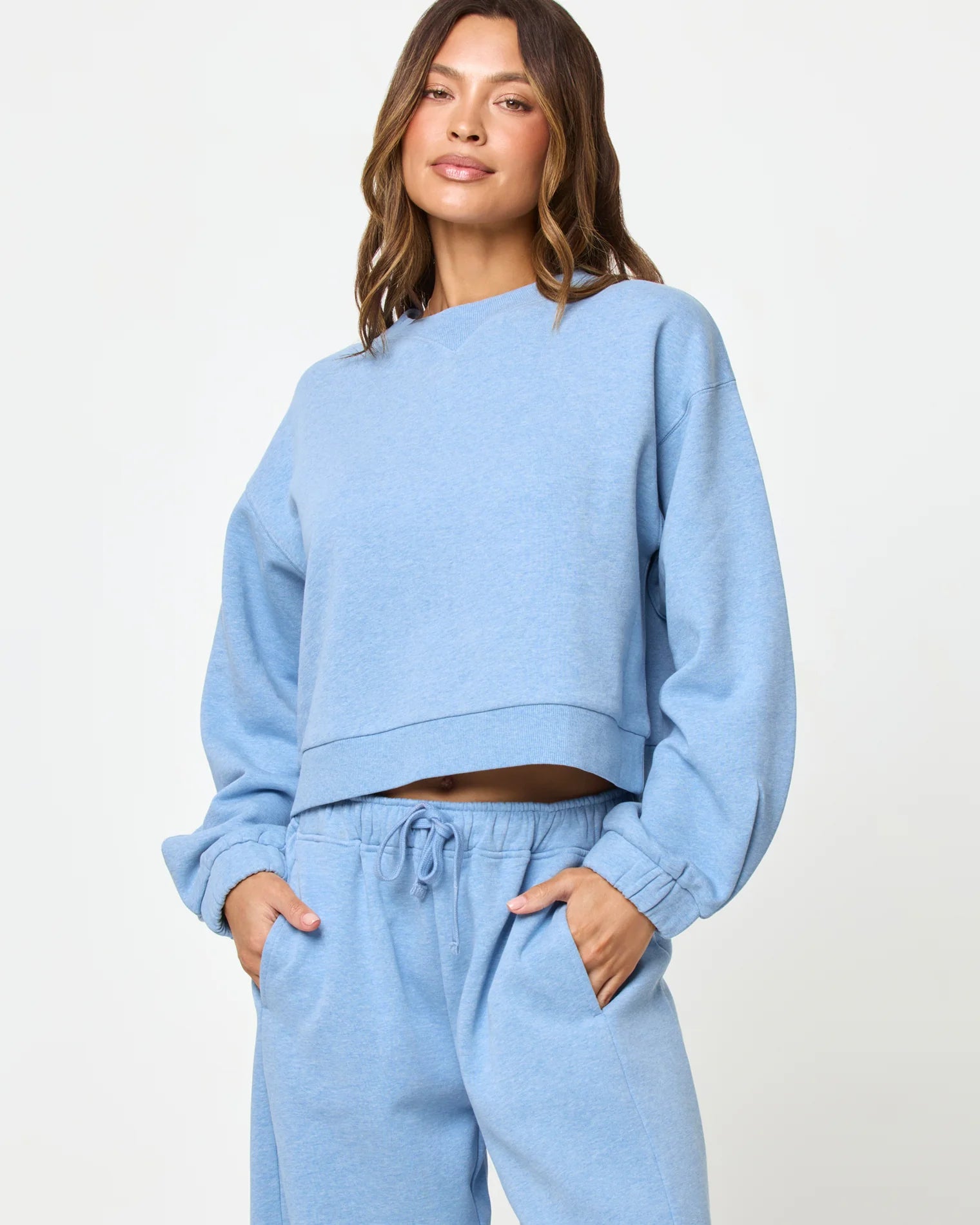 Woman wearing a light blue sweatshirt and pants 