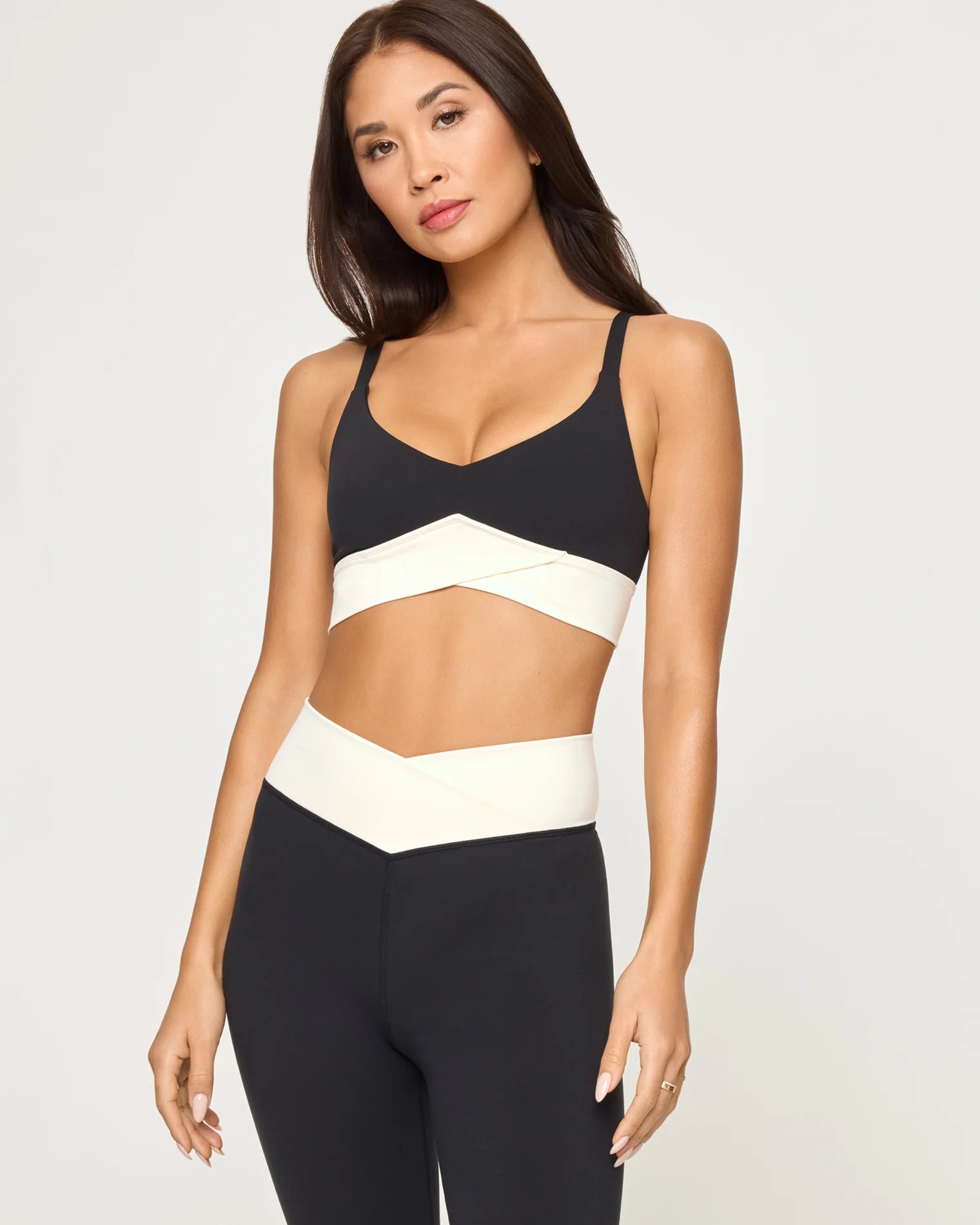 Woman wearing a black and white sports bra and leggings
