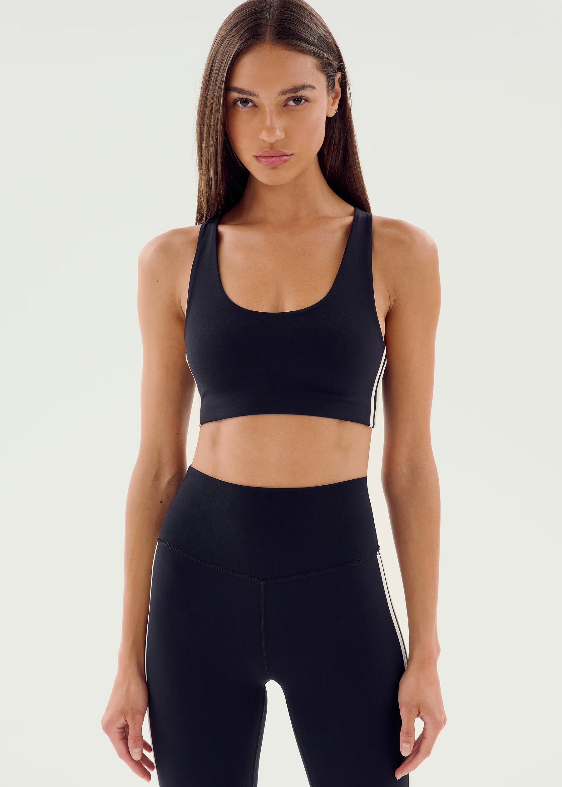Woman wearing a black sports bra and leggings