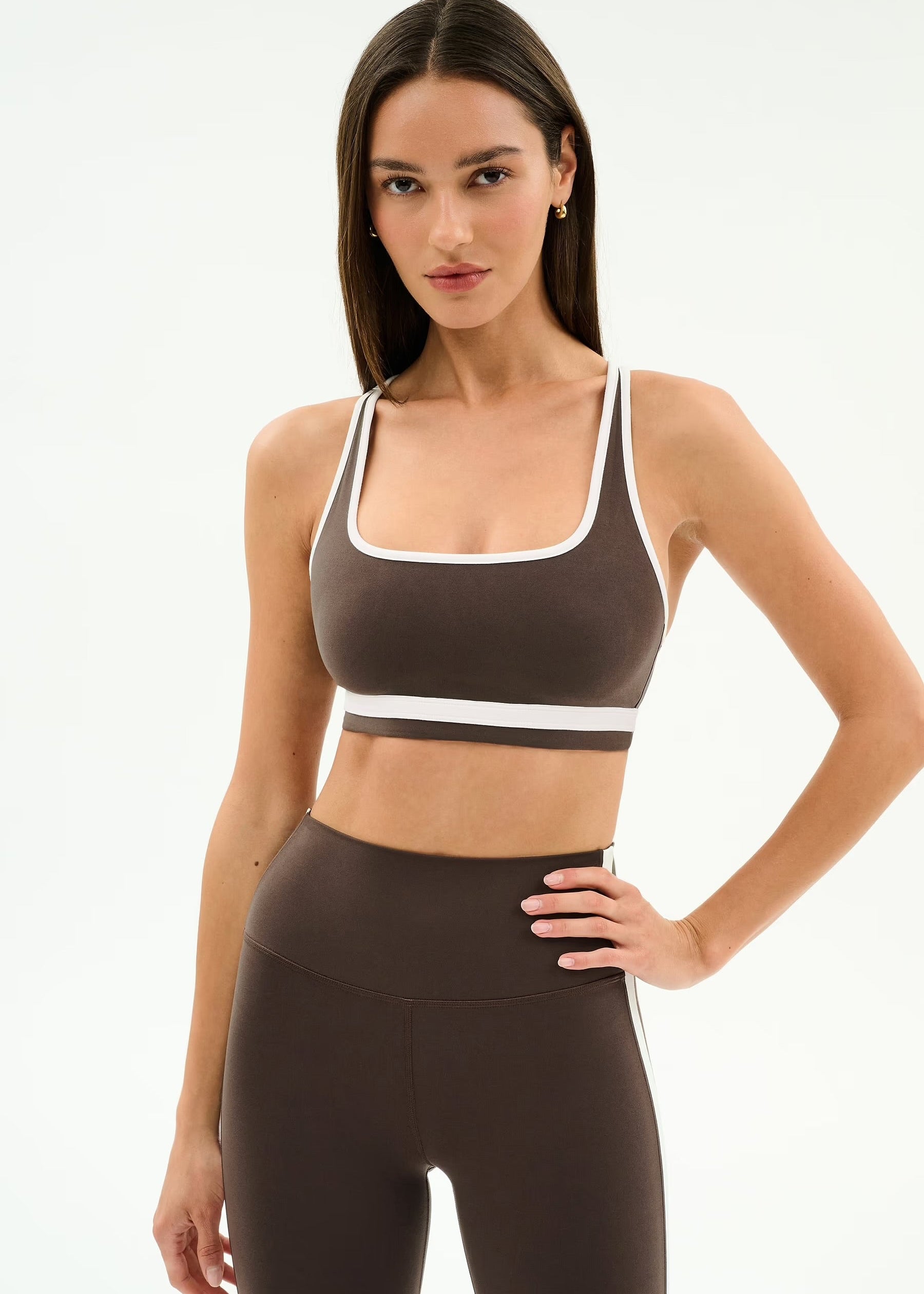 Woman wearing a brown sports bra and leggings