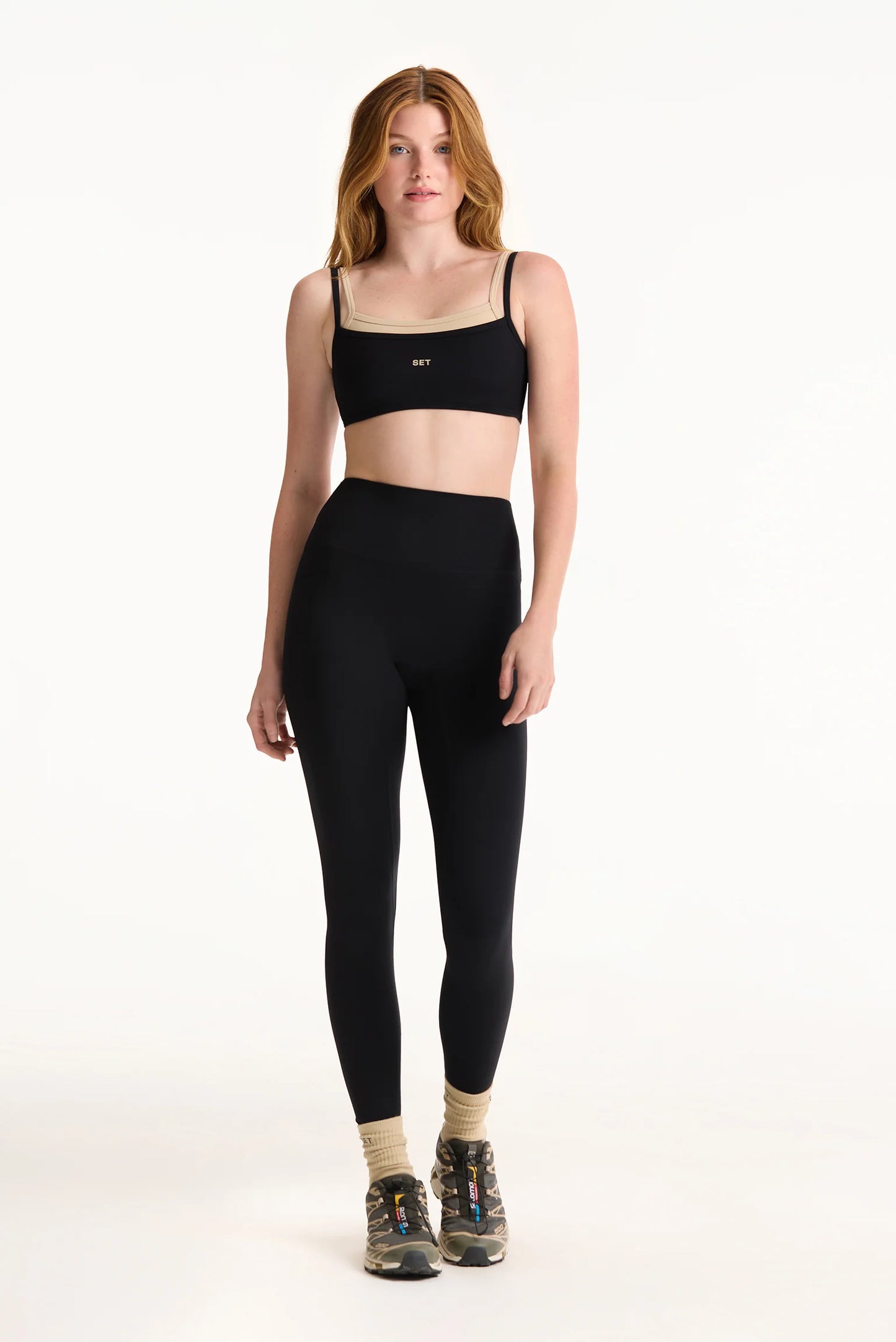 Woman wearing a black sports bra and leggings
