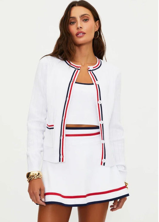 Woman wearing a white outfit with red and blue accents on a white background